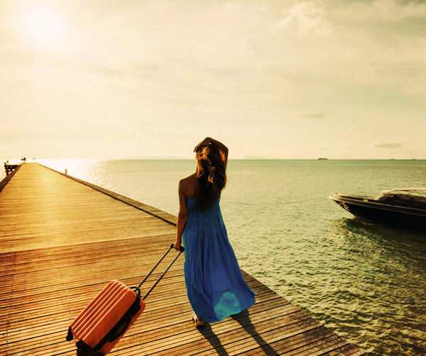 young-woman-with-suitcase-on-the-pier